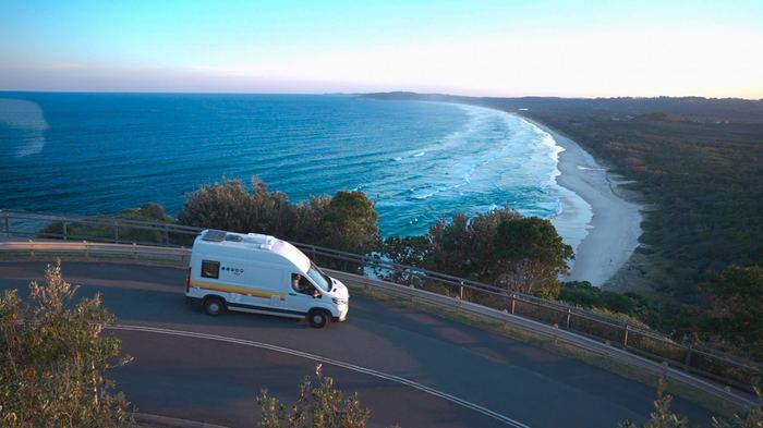 Campervan parked on scenic coastal road in Australia