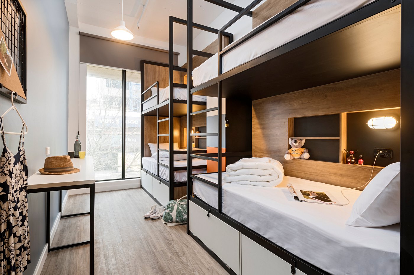 Hostel dormitory room with bunk beds and sunlight