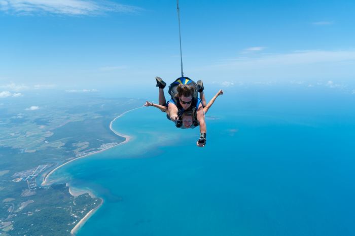 Skydiver freefalling over ocean